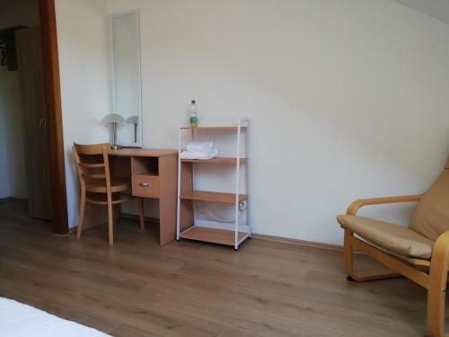 a room with a desk and a table and a chair at Hotel Hanseatic-garni in Wuppertal