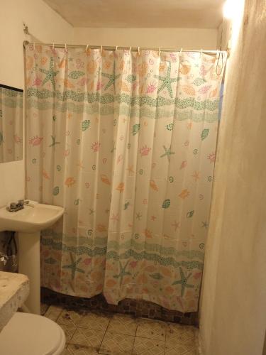 a bathroom with a shower curtain and a sink at Santa Rosa 4Rest in Monterrey