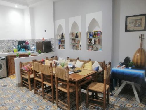 a kitchen and dining room with a table and chairs at Hostel Laksour in Marrakesh