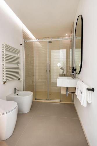 a bathroom with a tub and a sink and a shower at Open Hotel in Rimini