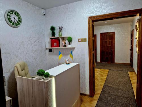 a lobby with a desk and a clock on the wall at Villa ZENKO in Lviv