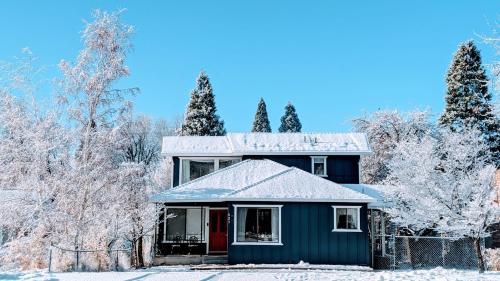 a blue house in the snow with trees at 4 Elements House:Central, Views-Every Rm, AC, Pets in Mount Shasta