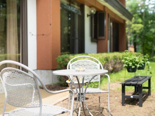 a table and two chairs on a patio at Yamanaka Lake ＲＹＯＺＡＮ - Vacation STAY 32157v in Yamanakako