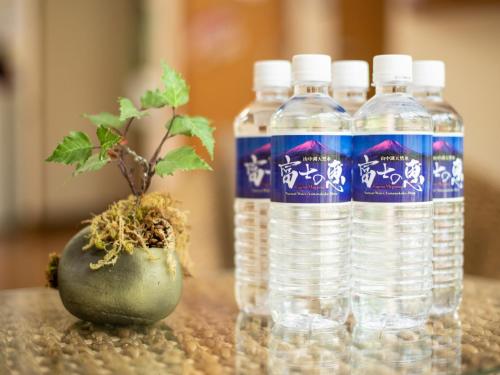 three bottles of water on a table with a plant at Yamanaka Lake ＲＹＯＺＡＮ - Vacation STAY 32157v in Yamanakako