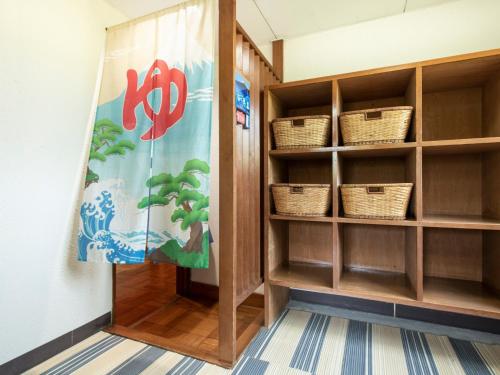 a library with baskets on shelves and a curtain at Yamanaka Lake ＲＹＯＺＡＮ - Vacation STAY 32160v in Yamanakako