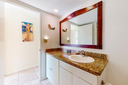 a bathroom with a sink and a mirror at Islander on the Beach 361 in Kapaa