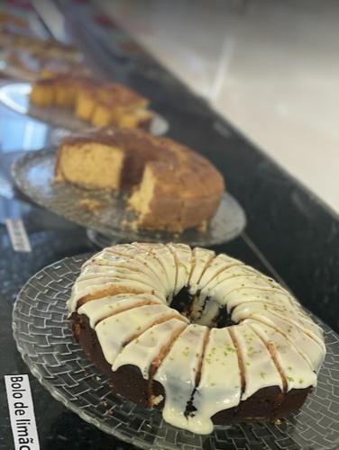 two donuts are sitting on plates on a table at Hotel Vitória in Vitória da Conquista