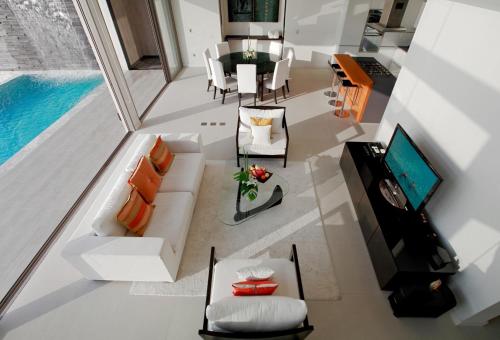 an overhead view of a living room with a pool at Cape Sienna Phuket Gourmet Hotel & Villas - SHA Extra Plus in Kamala Beach