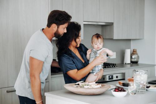 a family standing in the kitchen with a baby at Level Seattle Downtown - South Lake Union in Seattle