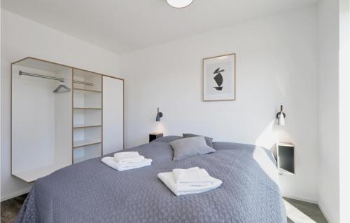 a bedroom with a bed with two towels on it at Stunning Apartment In Lembruch-dmmer See With Lake View in Lembruch