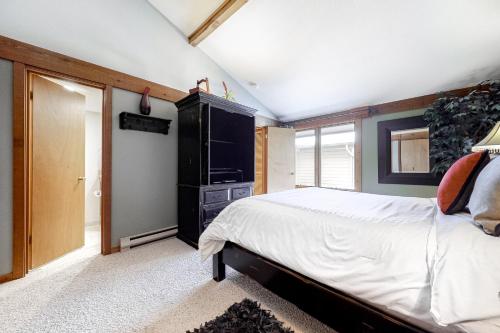 a bedroom with a large bed and a dresser at Golf Creek12 in Teton Village