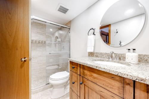 a bathroom with a toilet and a sink and a mirror at Golf Creek12 in Teton Village