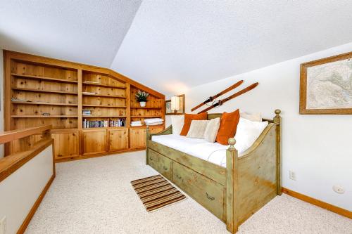 a bedroom with a bed and wooden cabinets at Golf Creek12 in Teton Village