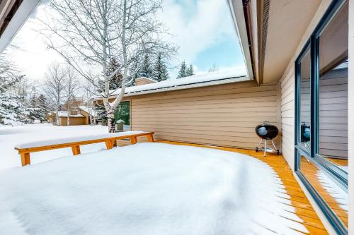 a porch covered in snow next to a window at Golf Creek12 in Teton Village