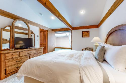a bedroom with a large bed and a television at Golf Creek 32 in Teton Village
