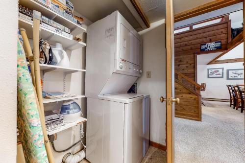 a small kitchen with a refrigerator and a stove at Golf Creek 32 in Teton Village
