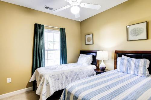 a bedroom with two beds and a window at Golf Retreat 832 in North Myrtle Beach