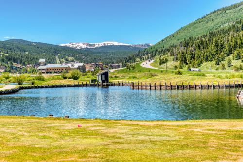 a lake with a dock in the middle of a field at Center Village Hideaway in Frisco