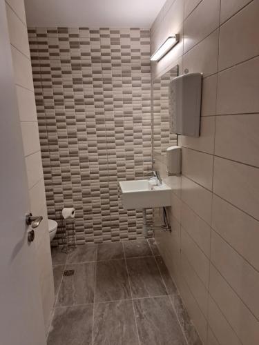 a bathroom with a sink and a toilet at La Veranda Hotel in Larnaka