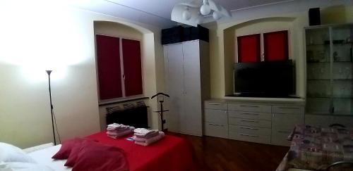 a bedroom with a red table and a tv at Smiths & Herreros in Genova