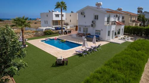 an aerial view of a house with a swimming pool at Dene Hollow Oroklini in Voroklini