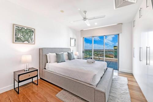 a bedroom with a large bed and a large window at Unparalleled Penthouse Luxury at Horizons 360 in Darwin