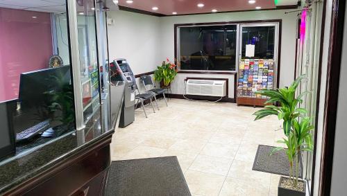 a room with a store with chairs and a window at Express Inn Newport News in Newport News