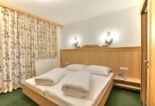 a bedroom with a large bed with white pillows at Apart Ehart in Sankt Anton am Arlberg