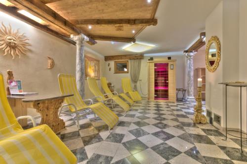 a living room with yellow chairs and a checkerboard floor at Apart Ehart in Sankt Anton am Arlberg