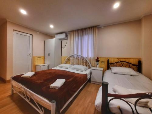 a bedroom with two beds with white pillows at NOVEL HOUSE in Martvili