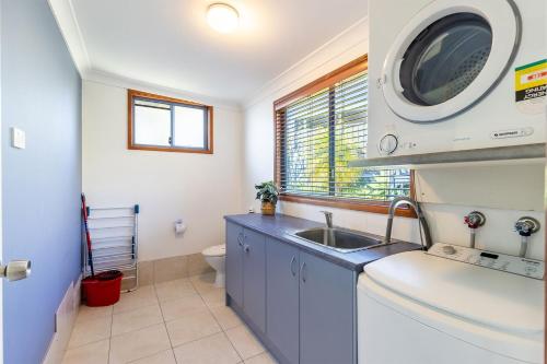 une petite salle de bain avec un lavabo et des toilettes dans l'établissement Baggies On Dutchies, 9 Burbong Street - Large pet friendly house with spectacular waterviews, Wi-Fi and air con, à Nelson Bay