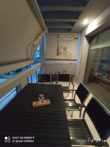 a room with a table and chairs and a bike on the wall at Lia Luxury home 2ΥΔ 110 τ μ in Chrysoupolis