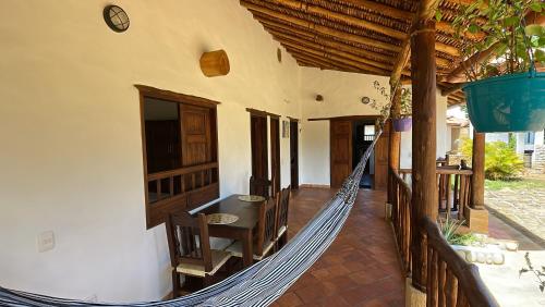 a porch with a hammock in a house at cabañas villa Angelica in Barichara