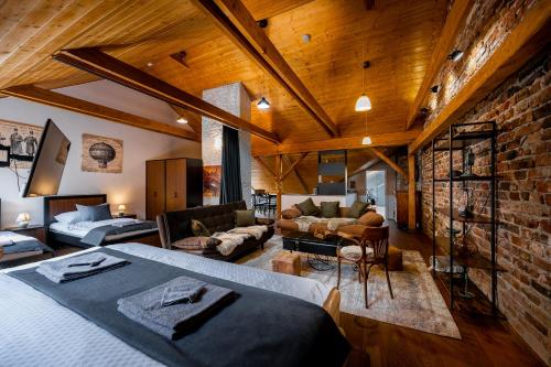 a bedroom with a bed and a brick wall at Vintage Industrial City Apartments in Košice