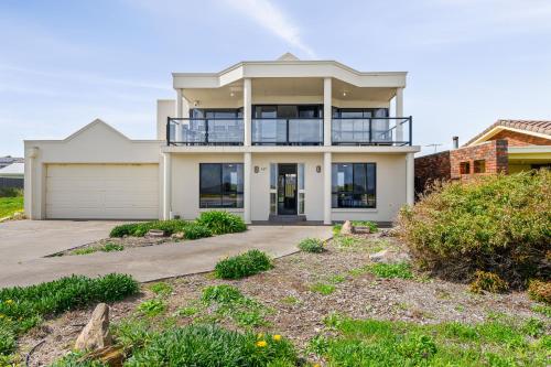 a large white house with a garage at Mareblue Villa - Aldinga Beach - C21 SouthCoast Holidays in Aldinga Beach