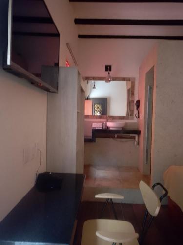 a living room with a table and chairs in a room at Hotel Sonno Plaza Allende in Mexico City