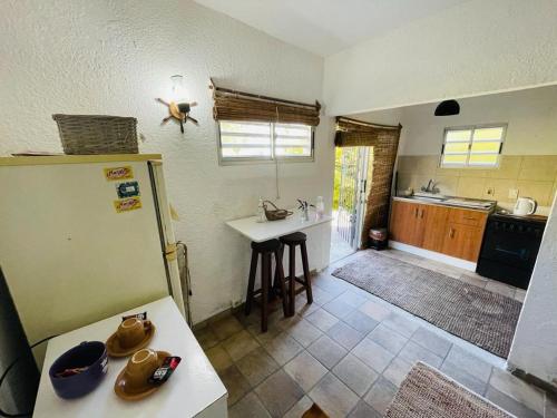 a kitchen with a refrigerator and a table in it at Costa Villa in Atlántida