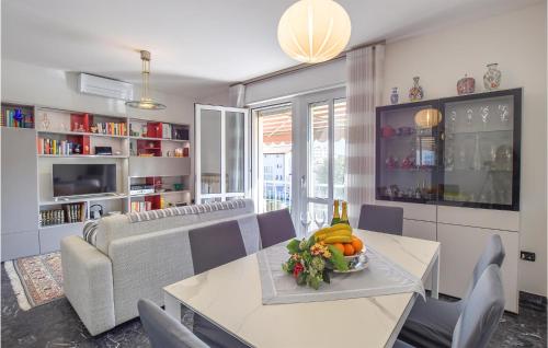 a living room with a table and a couch at Stunning Apartment In Abano Terme in Abano Terme
