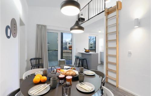 a dining room with a table with food on it at Lovely Home In Lembruchdümmer See in Lembruch