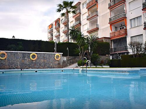 a large swimming pool in front of some buildings at Inviting apartment in Torremolinos with shared pool in Torremolinos