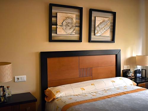 a bedroom with a bed and three pictures on the wall at Inviting apartment in Torremolinos with shared pool in Torremolinos