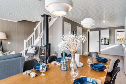 a dining room with a wooden table with blue dishes on it at Rorsundet Brygge in Vega