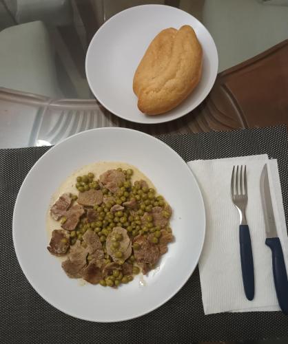 two plates of food with meat and bread on a table at Casa taina in Jarabacoa
