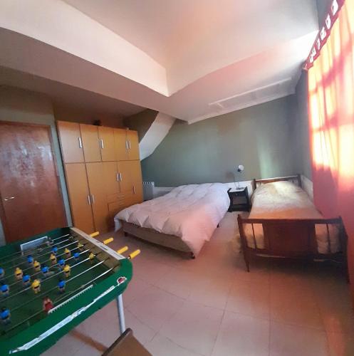a bedroom with a bed and a pool table at Cabaña El Horizonte Patagónico in Ushuaia