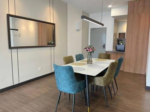 a dining room with a table and chairs at Attractive 3 Bedroom Condo with Pool-D Raudhah Homestay in Kajang