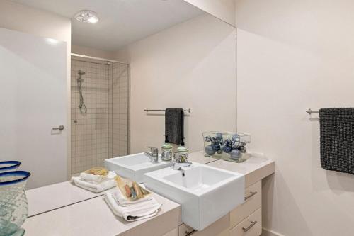a white bathroom with a sink and a shower at Point Grey Apartment 2 in Lorne