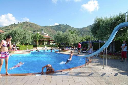 a group of people playing in a swimming pool at Residence Fontana Barone, Cefalu in Cefalù