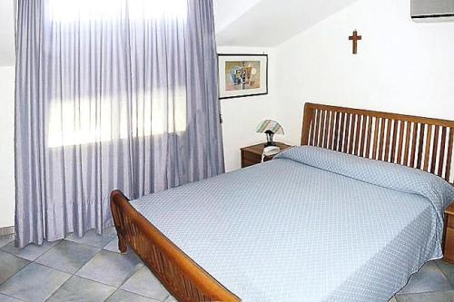 a bedroom with a bed and a window at Residence Fontana Barone, Cefalu in Cefalù