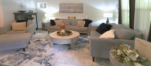 a living room with two couches and a table at Stay at The Retreat! Gatlinburg-Dollywood in Sevierville