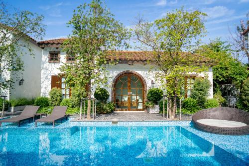 a house with a swimming pool in front of a house at Villa Seville in Hua Hin